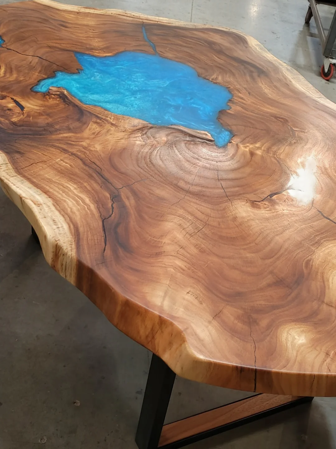 Table en bois massif avec insertion d'époxy bleue